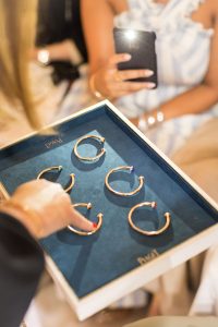 Sales lady showcasing 5 new bracelets at the Piaget event by Loesje Kessels Fashion Photographer Dubai